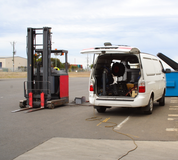 Contractor working at airport with tools and equipment in a white van
